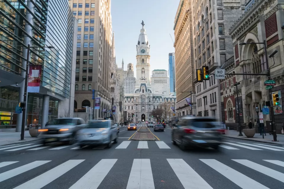 View from middle of crosswalk of Phialdelphia City Hall with blurred traffic.